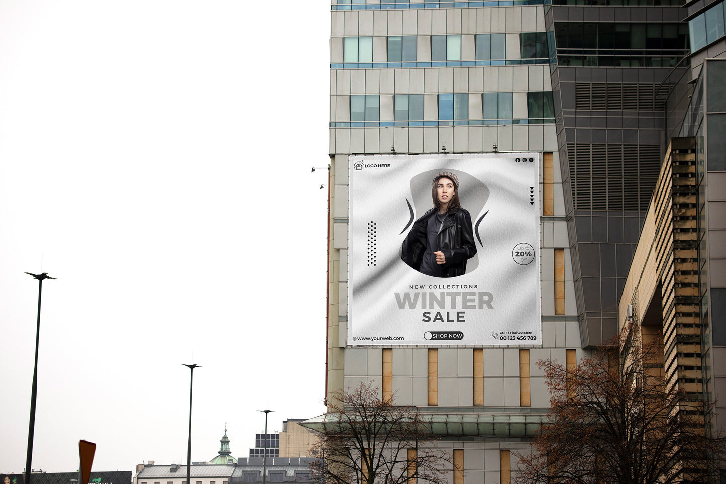 a billboard advertises a winter sale in front of a tall building